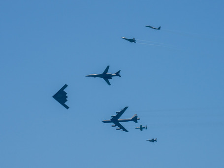 Several bombers and fighter jets in formation just above the sea at Miami Beach for the 2025 Sea and Air Show
