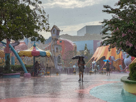 A lone walker in the heavy rain in Universal Park